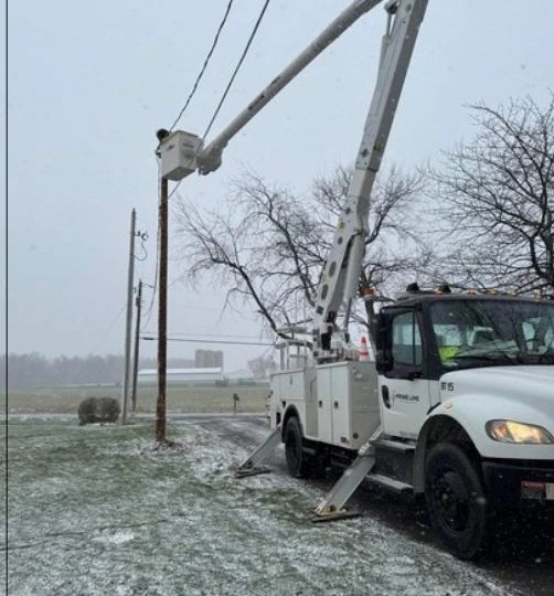 Prime Line Power bucket truck working in snow